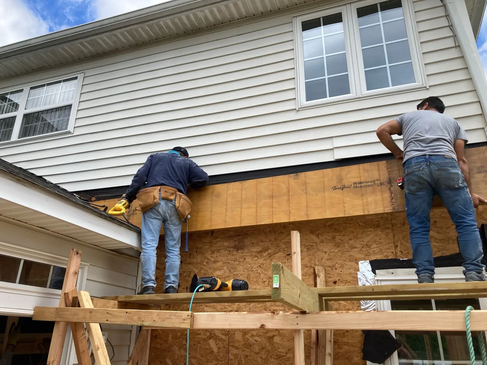 Arch GC crew installing siding on a home